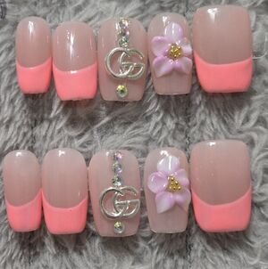Designer Inspired Pink French Tip Press-On Nails with Floral Accent